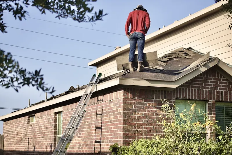 Professional roofer working on a residential roof in La Sierra South
